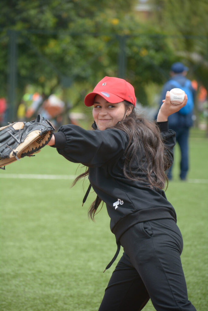Young female athlete throwing baseball